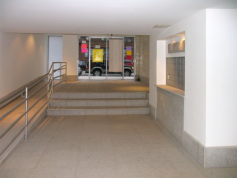 building lobby with marble tile floor and stairs