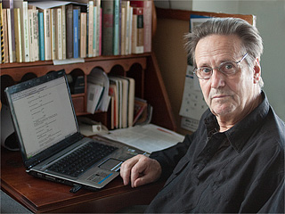 Robert Anthony writing at his desk
