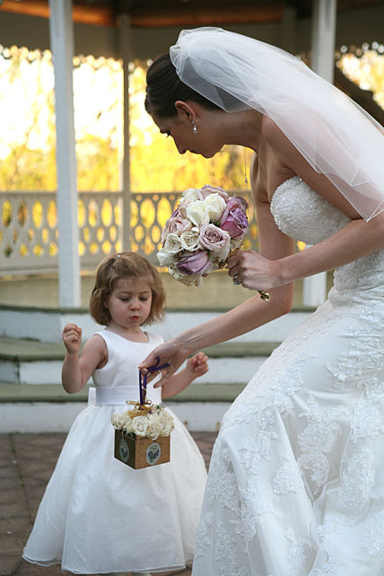 Bride giving flowers to flower girl